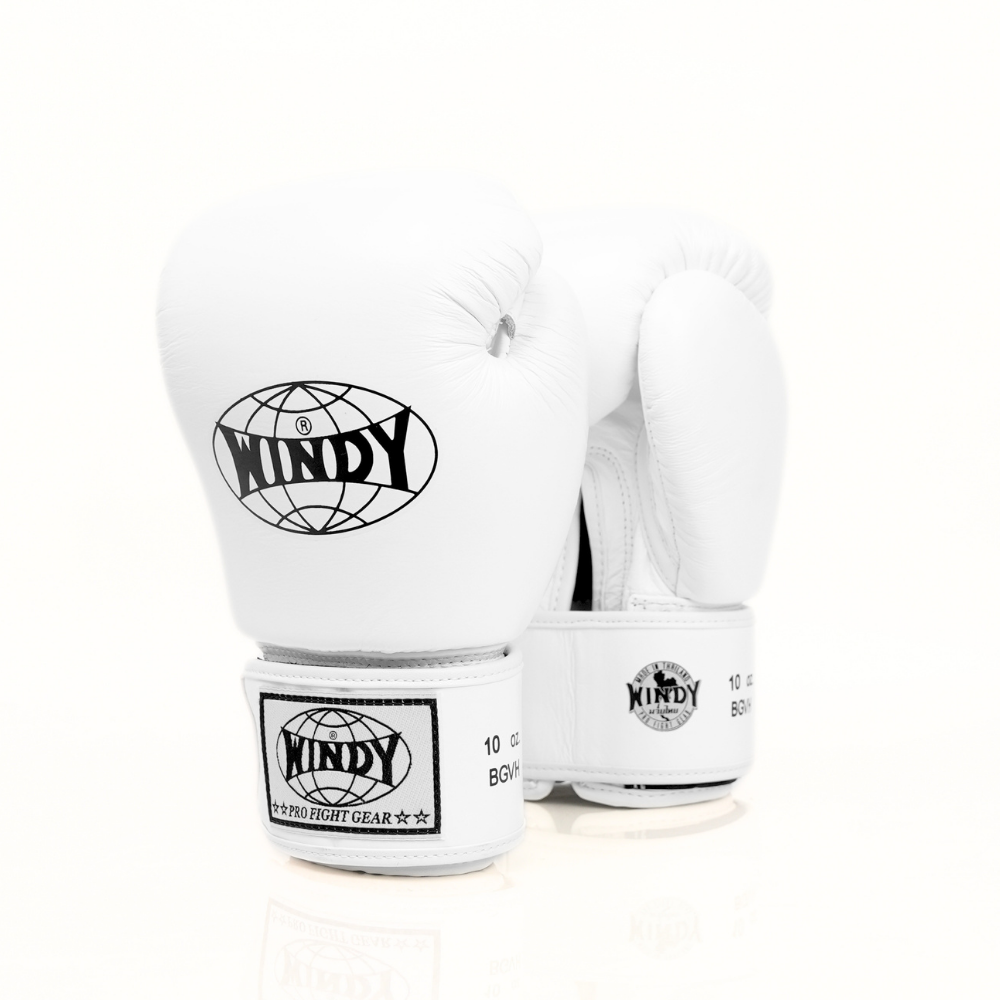 Angled view of white Windy BGVH leather Muay Thai boxing gloves showing padded knuckles, black logo details and hook-and-loop wrist closures on a white background