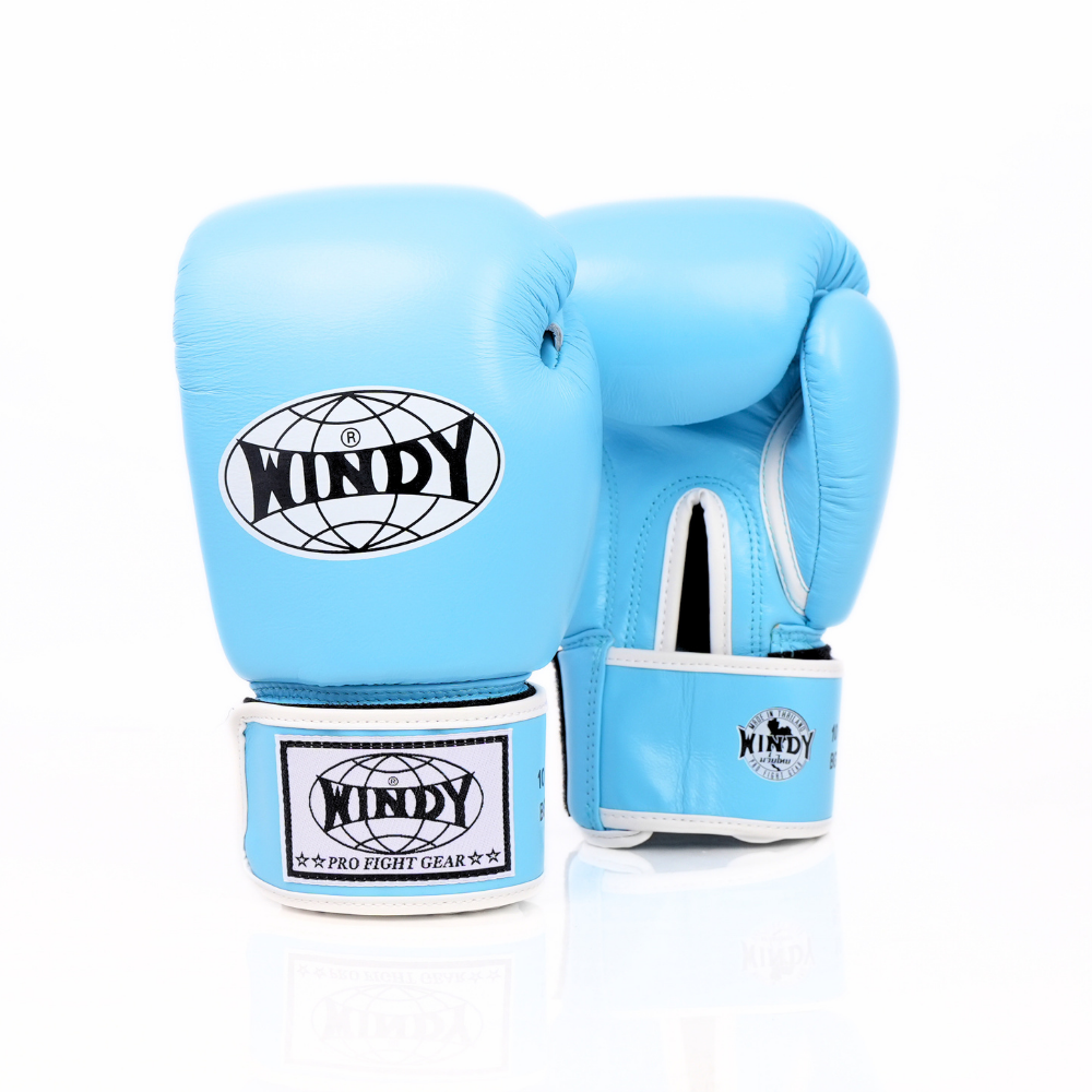Front view of light blue Windy BGVH Muay Thai boxing gloves showing padded knuckles, thumb protection, wrist cuffs and Windy branding on a white background
