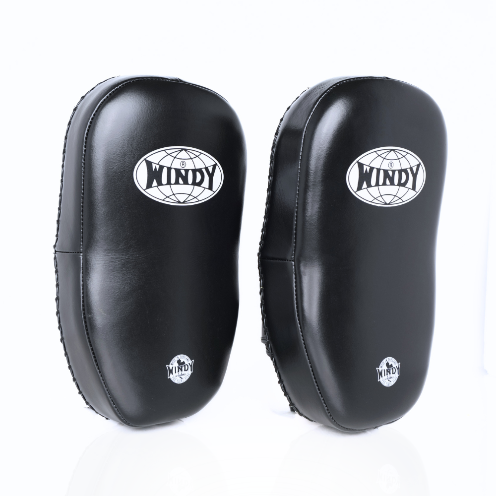Angled view of black Windy KP-8 leather kick pads showing double straps, curved impact padding and Windy branding on a white background