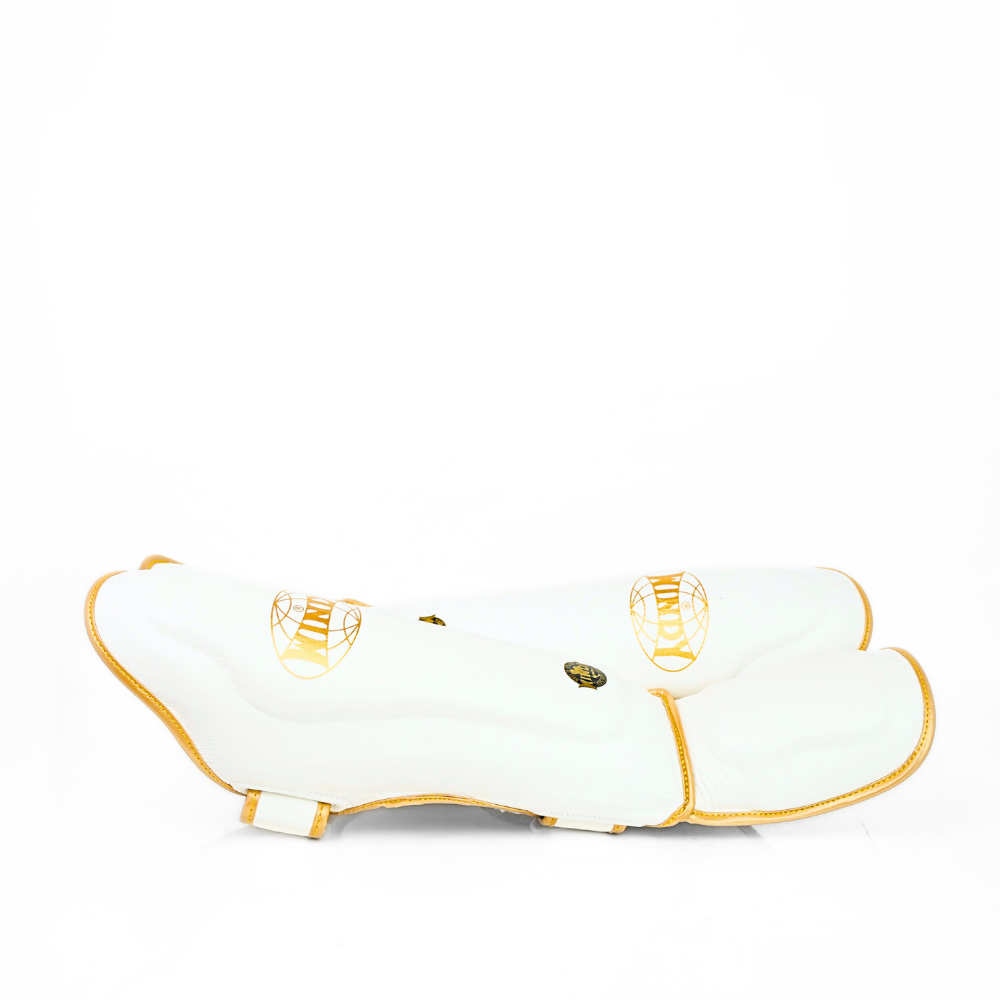 Windy LP3 white and gold Muay Thai shin guards with full-length leg and instep protection, padded shin support and Windy branding on a white background