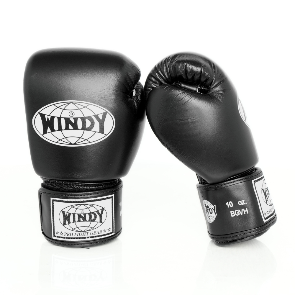 Front and angled side views of black Windy BGVH leather Muay Thai boxing gloves showing padded knuckles, Windy logos, wrist strap details and size marking on a white background