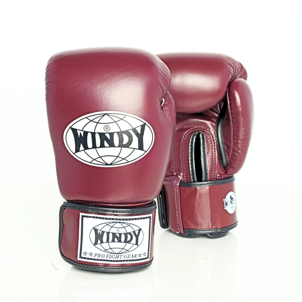 Front view of maroon Windy BGVH Muay Thai boxing gloves showing padded knuckles, thumb protection, wrist cuffs and Windy branding on a white background