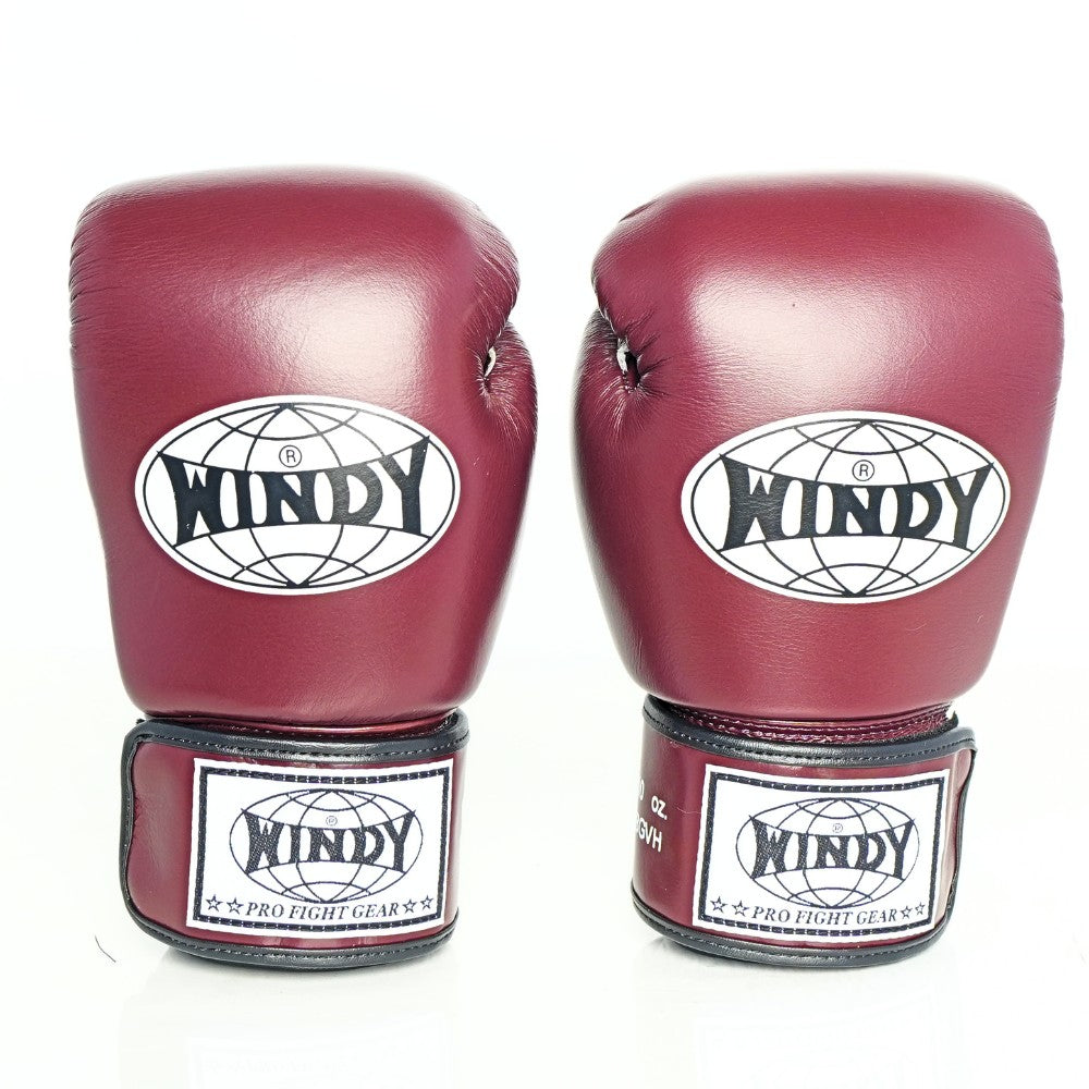 Side view of maroon Windy BGVH Muay Thai boxing gloves showing the padded glove profile, thumb guard and extended wrist cuff on a white background