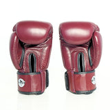 Front view of a pair of burgundy Windy BGVH leather Muay Thai boxing gloves showing padded knuckles, black thumb guards, stitched leather panels and hook-and-loop wrist closures on a white background