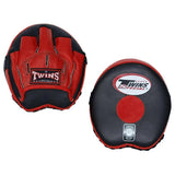 Front view of a black and red Twins Special PML-13 speed focus mitt pair showing the hand compartment and circular target pad on a white backgroundTwins Special PML-13 speed focus mitts in black and red with padded hand compartments and circular target pads for boxing and Muay Thai speed training on a white background