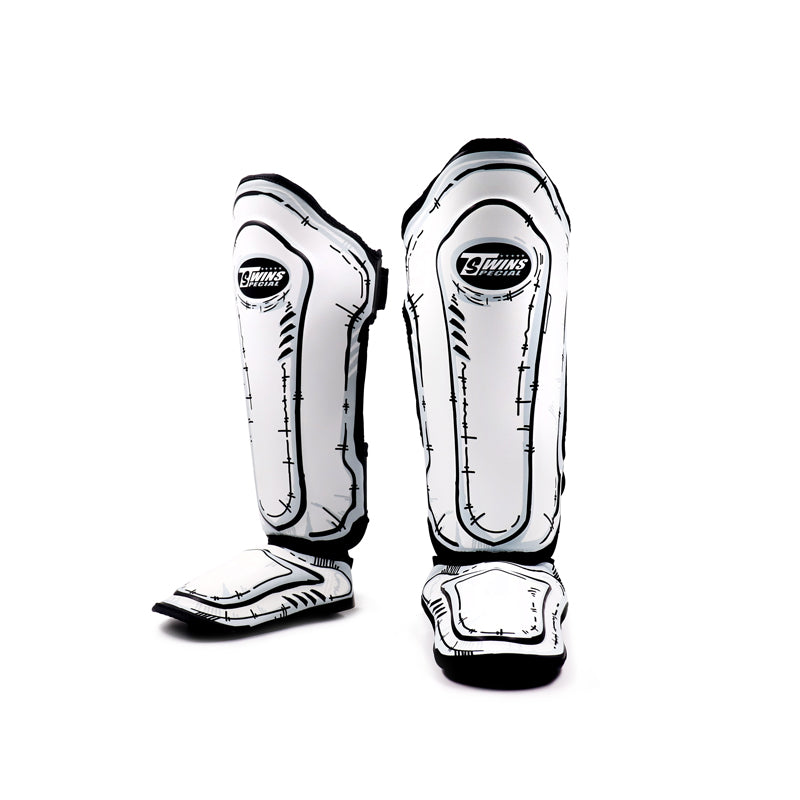 Front view of Twins Special FSGL10-66 COMIC leather shin guards showing full shin and instep coverage, protective foam padding and hook-and-loop closures on a white background