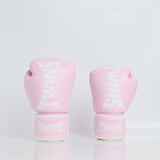 Front view of a pair of light pink Twins Special boxing gloves with white branding and hook-and-loop wrist straps displayed on a reflective white surface