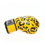 ThaiSmai FBG124 Leopard Muay Thai boxing gloves in genuine leather with yellow-and-black leopard print, padded knuckles and secure wrist support, pair on a white background